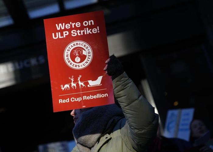 Thousands of Starbucks workers go on a one-day strike on one of the chain's busiest days of year