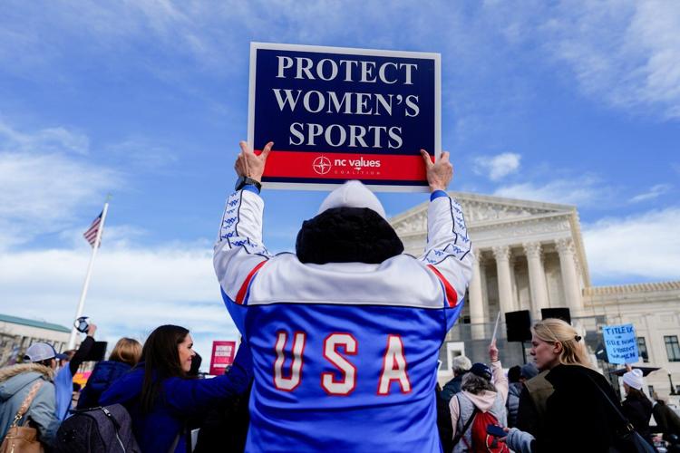 Photos of demonstrators outside the Supreme Court as it considers upholding transgender sports bans