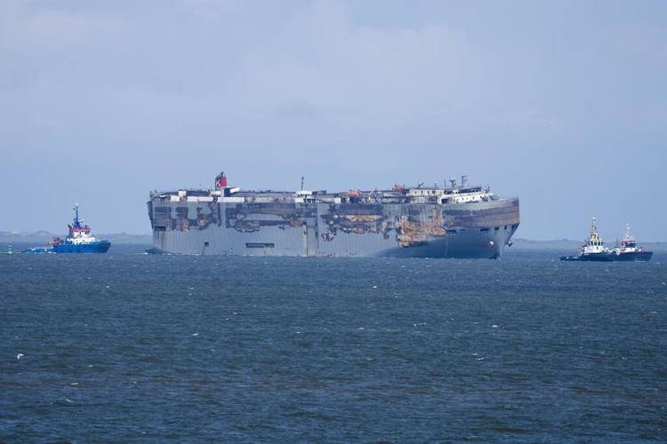 A car-carrying ship that burned for a week on the North Sea will be towed to a Dutch port