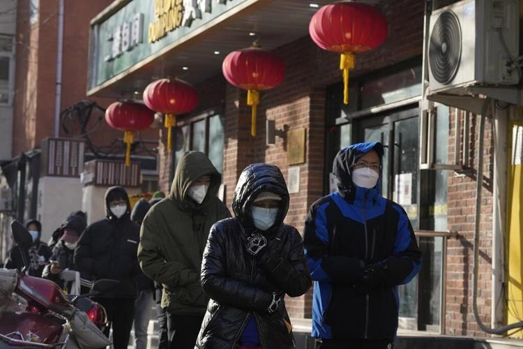 China reduces COVID-19 case number reporting as virus surges