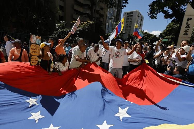 Dueling political factions demonstrate in Venezuela's capital as presidential election race heats up