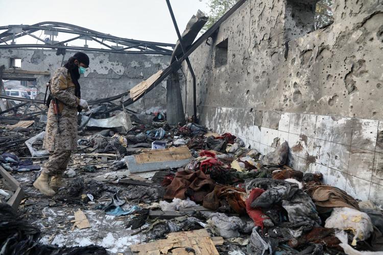 Rescue crews race through rubble after a deadly Kabul airstrike, in photos