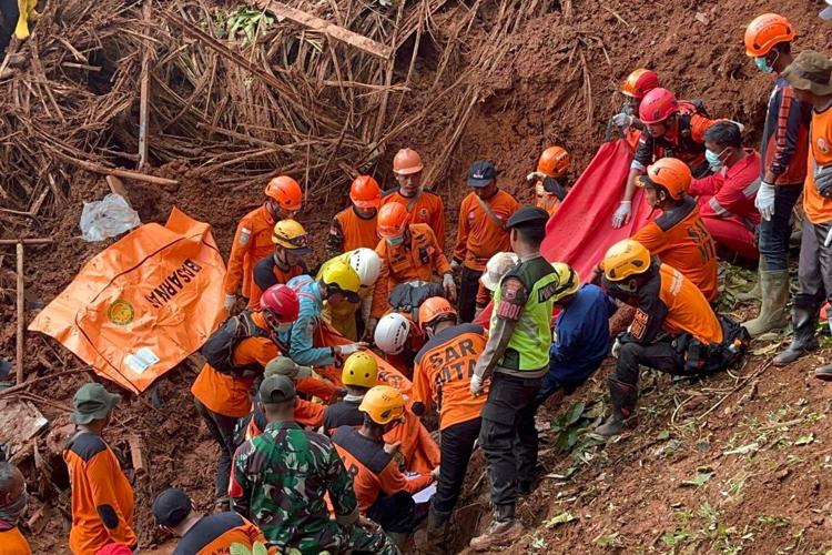 Indonesian rescuers search for nearly three dozen people after landslides killed at least 18 people