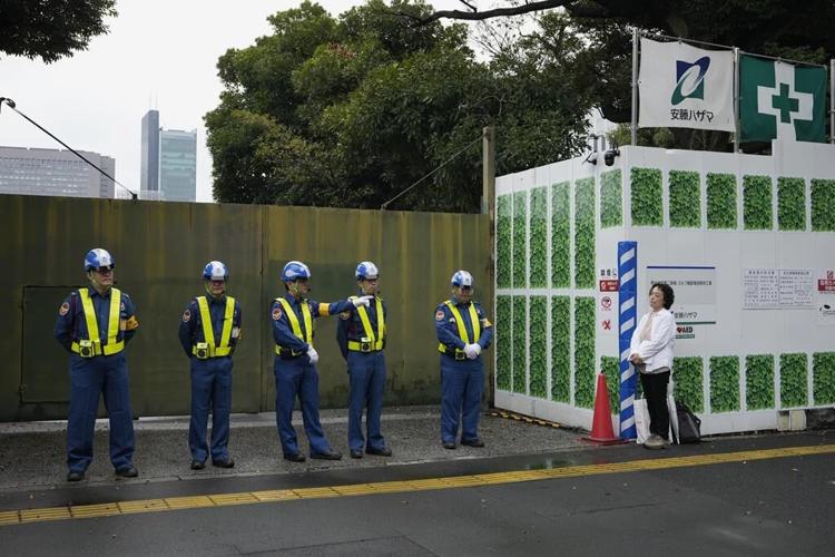 Developers begin cutting trees in a Tokyo park that environmentalists want to protect