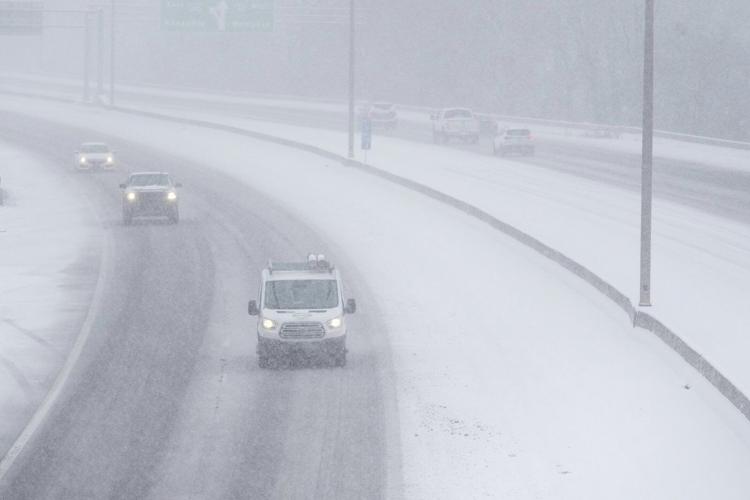 Powerful winter storm dumps heavy snow, causing flight delays, slick roads and school closings
