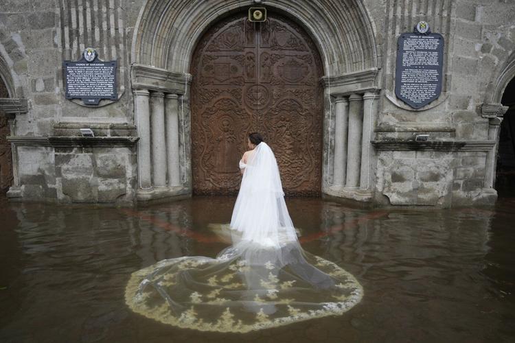 Photos show a Filipino couple walking down a flooded aisle on their wedding day