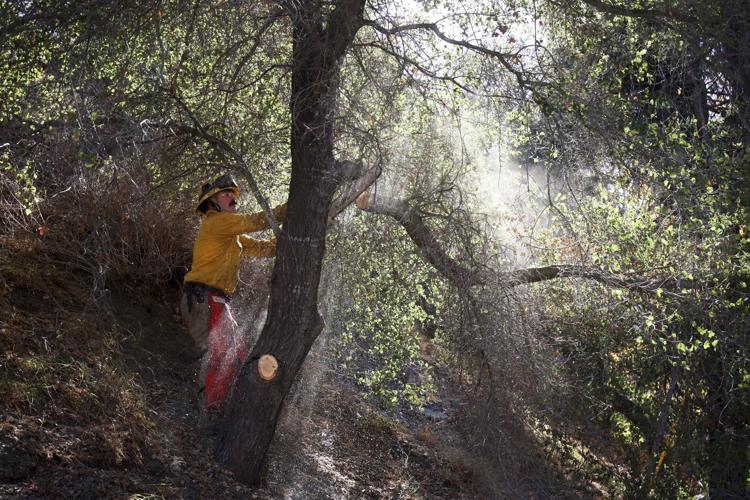 New wildfire warnings issued and more power is shut off as winds rise in Southern California