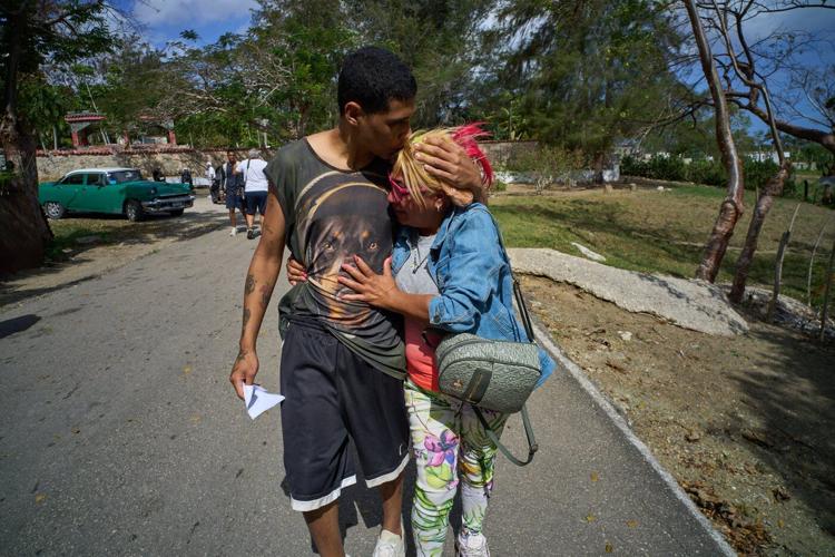 Photos of freed prisoners reuniting with families outside a Cuban prison