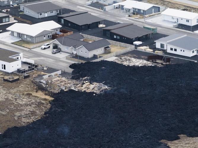 Iceland faces daunting period after lava from volcano destroys homes in fishing town, president says