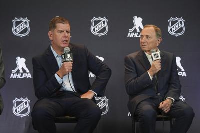 NHL to implement a playoff salary cap beginning this season, AP source says