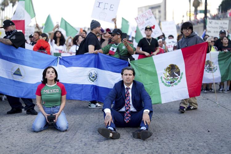 Marchers protesting planned deportations block major freeway in Los Angeles