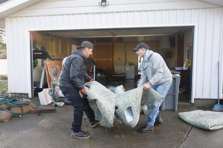 Arctic air sweeps south as residents of the Pacific Northwest remain on guard after severe flooding