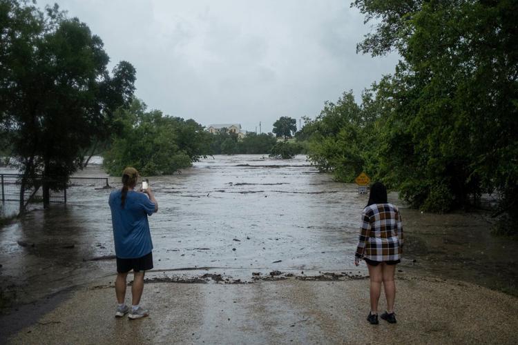Texas flooding surges from huge rainstorms as rescuers pull people from rising waters