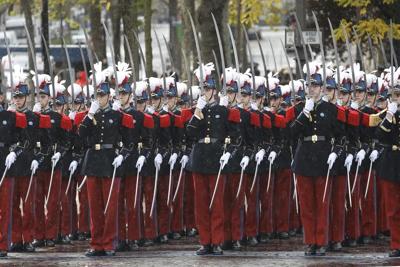 Somber bugles and bells mark Armistice Day around the globe as wars drown out peace messages