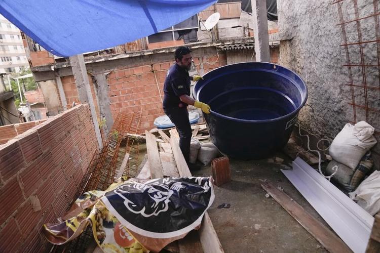 To fight dengue epidemic, health agents in Brazil scour junkyards and roofs for mosquitos