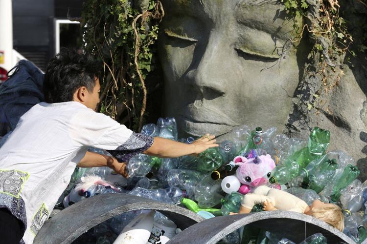 Artist drowns sculpture in plastic waste in front of the UN during plastic pollution treaty talks