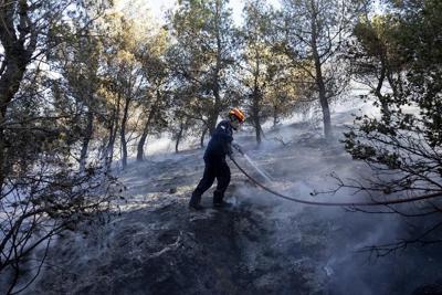 Firefighters battle wildfires on 2 Greek islands as premier warns of a dangerous summer