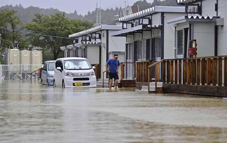 Rescue workers search for at least 6 people missing after heavy rain pounds Japan’s Noto region