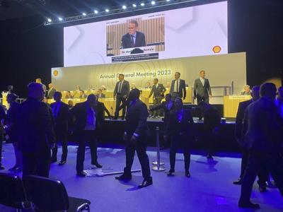 Climate protesters dragged from Shell shareholder meeting as they rush stage