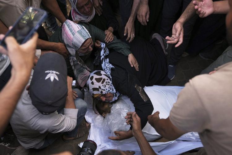 Photos show people mourning after airstrikes and shooting in Gaza overnight