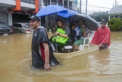 Fierce storm blows out of northern Philippines after leaving 14 dead in landslides and floods