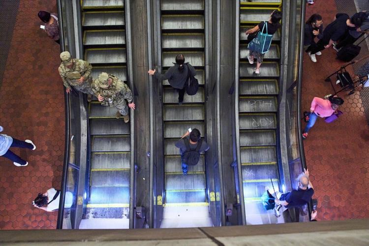Photos of week three of Washington's federal takeover, as troops on patrol start carrying guns