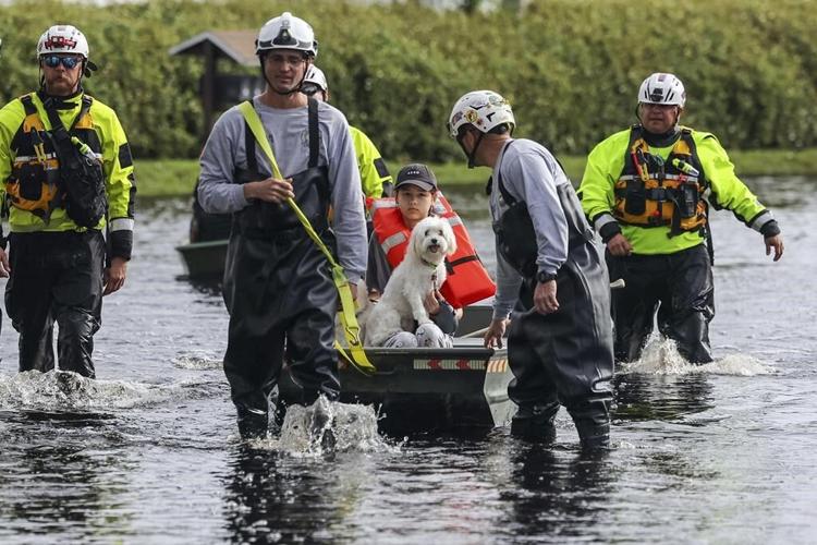 Residents slog through flooded streets, clear debris after Hurricane Milton tore through Florida
