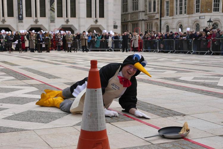 Photos of Londoners in costume sprinting with frying pans on Pancake Day