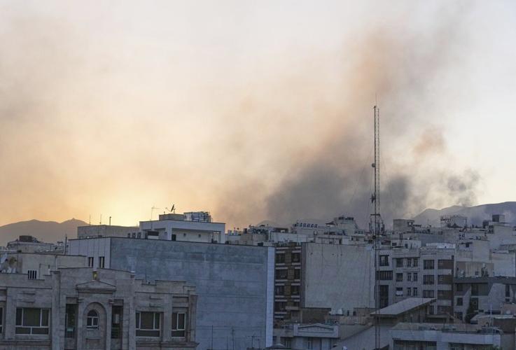 The Latest: Dozens wounded in Iranian strikes across Israel, as Israel hits Arak reactor site