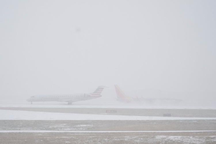 People brace themselves for the winter storm moving across the US, in photos