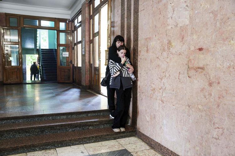 AP PHOTOS: 3 Ukrainian siblings buried after Russian missile strike