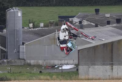 2 men are killed when their helicopter crashes into a hog house in central Ireland