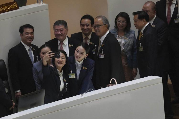 Thai prime minister survives a challenge by rivals who say her father is pulling the strings