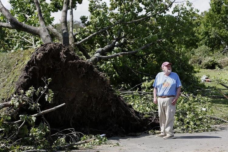 Rare New England tornado lifts car from a highway as strong storms damage homes and flood roads