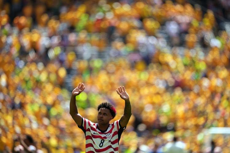 US reaches World Cup knockout round and wins its group with 2nd straight victory, 2-0 over Australia