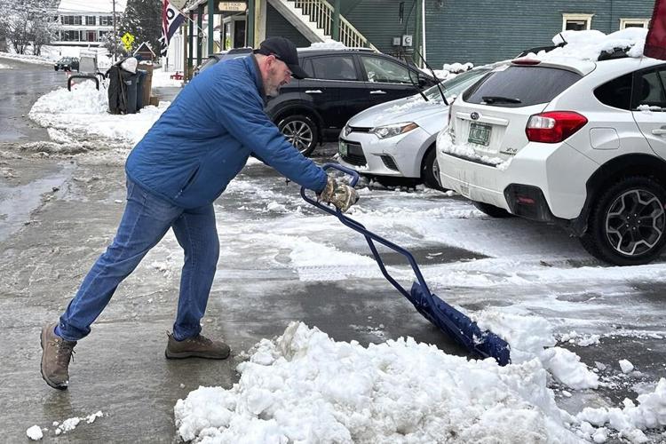Heavy snowfall drops tree branches onto power lines, causing outages in New England