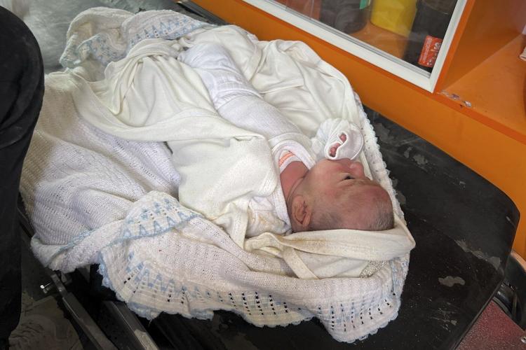 A month-old girl is pulled from the rubble in Gaza after an airstrike killed her parents
