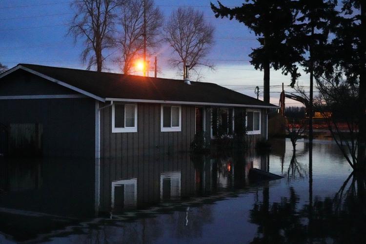 Arctic air sweeps south as residents of the Pacific Northwest remain on guard after severe flooding