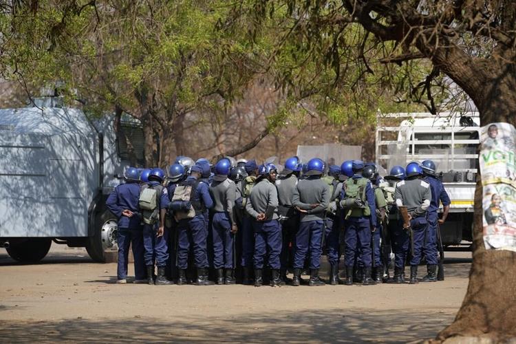 Zimbabweans anxiously wait for election results as armed police gather with water cannons
