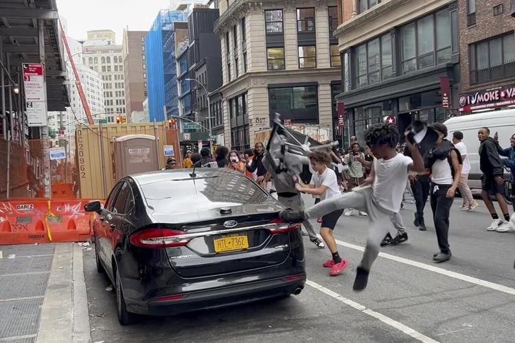 Crowd overwhelms New York City's Union Square, tosses chairs, climbs on vehicles