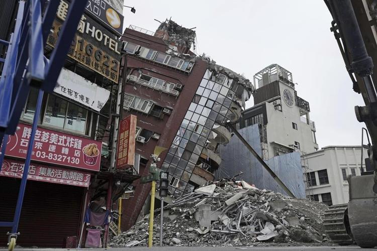 Earthquake aftershocks halt the demolition of a leaning building in Taiwan. Death toll rises to 13