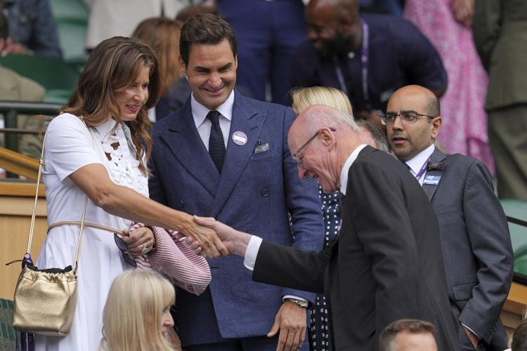 Roger Federer sits in Wimbledon's Royal Box to watch rival Novak Djokovic win