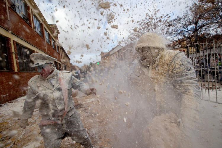 Photos show flour, eggs and firecrackers flying at Spain's Els Enfarinats festival