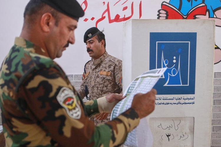 Photos show Iraqi security forces and displaced people voting early in parliamentary election