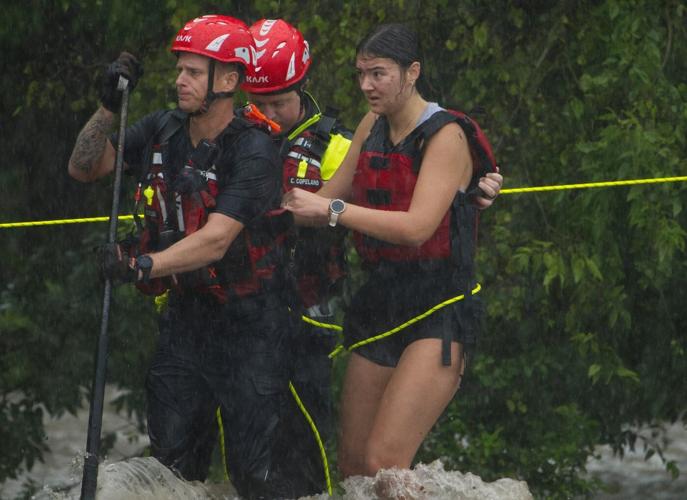 Texas flooding surges from huge rainstorms as rescuers pull people from rising waters