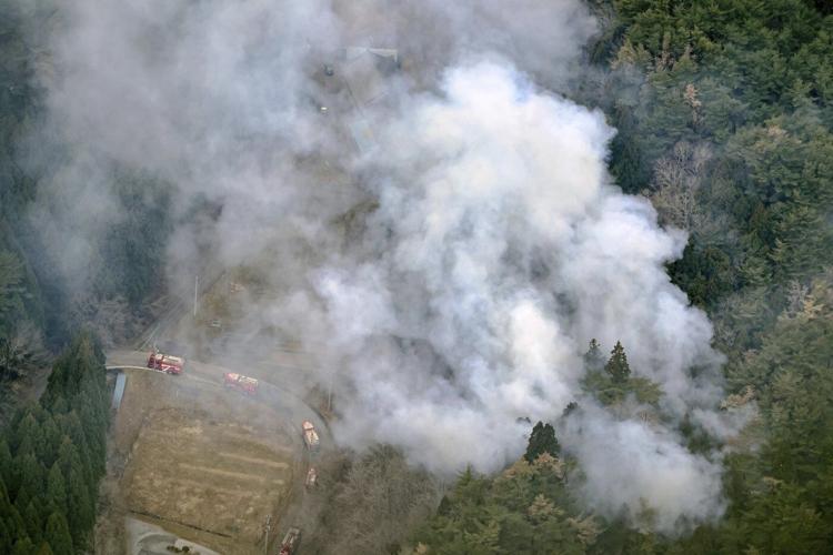 Japan fights a forest fire that has damaged dozens of homes and caused hundreds to evacuate