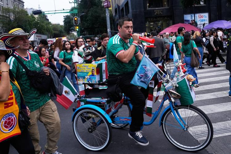 Rescue dog Osito steals hearts at the World Cup, one bike ride at a time