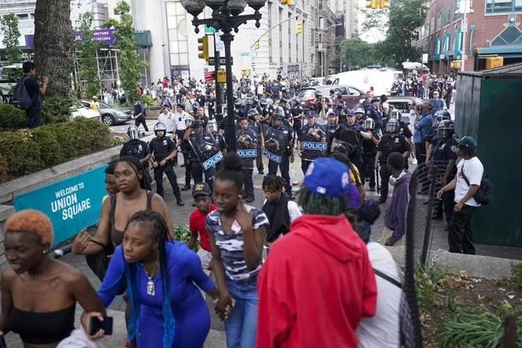 Crowd in the thousands overwhelms New York City's Union Square, tosses chairs, climbs on vehicles