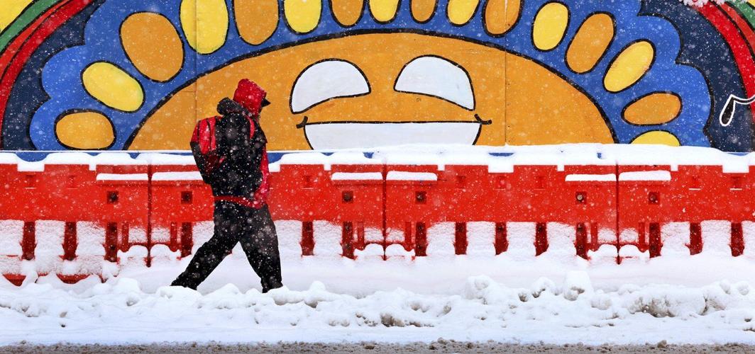 Powerful winter storm dumps heavy snow, causing flight delays, slick roads and school closings