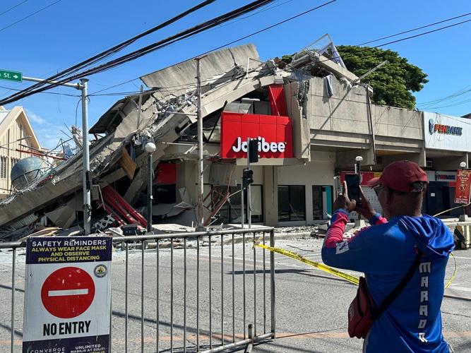 A 7.8 magnitude quake in the Philippines kills at least 19, fells buildings and sets off a tsunami